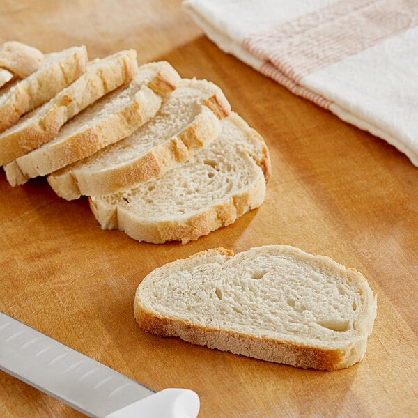 Sliced bread on a cutting board with a knife.