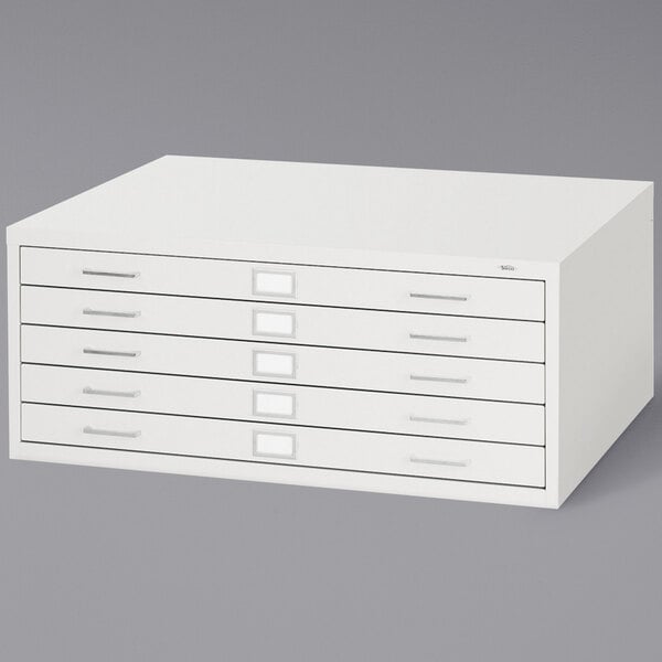 a white file cabinet with drawers