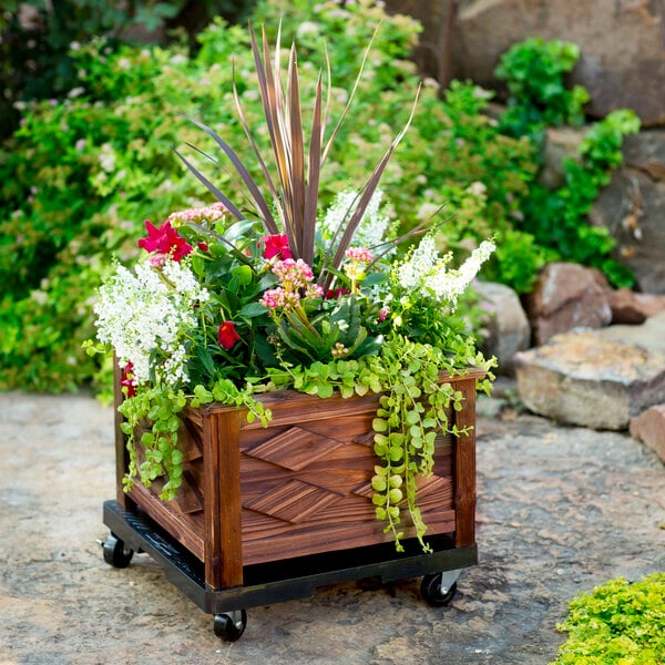 A DeVault planter dolly with flowers and plants in it.