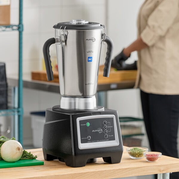 A large stainless steel commercial food blender with a digital control panel and dual handles.