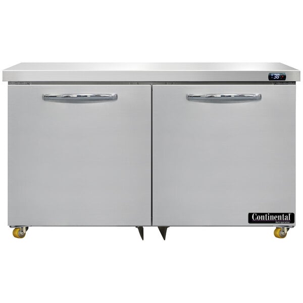 A white refrigerator with two stainless steel doors under a counter.