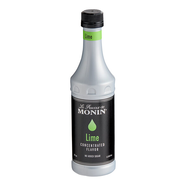 A white Monin bottle of lime concentrate with a black label.