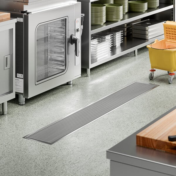 A 12-inch by 84-inch stainless steel floor trough with a grate, designed for commercial kitchen drainage.