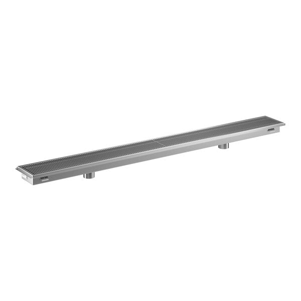 A long, rectangular stainless steel floor trough with a grated cover.