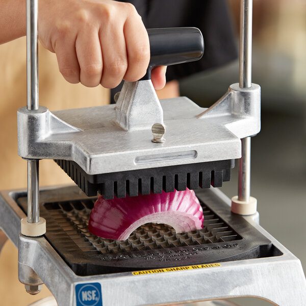 A person using a Vollrath dicer to cut an onion.