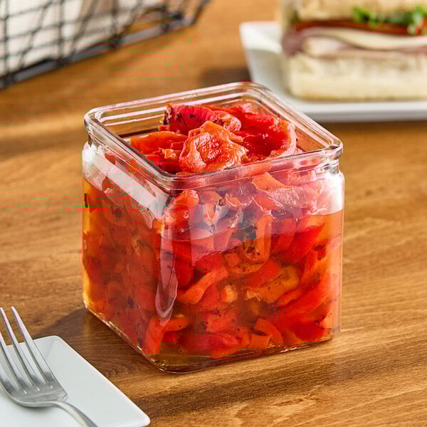 A GET clear glass storage jar filled with red peppers.