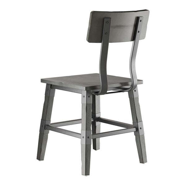 A Lancaster Table & Seating industrial chair with a slate gray finish and wooden back and seat.