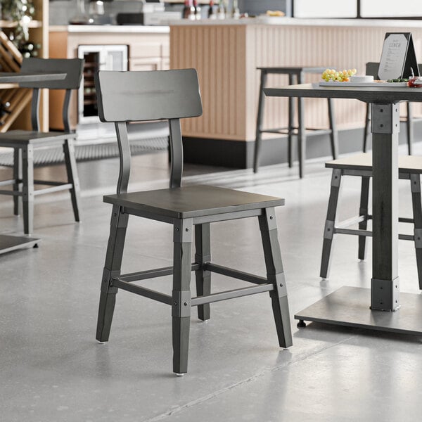 A Lancaster Table & Seating industrial chair with a table in a restaurant.
