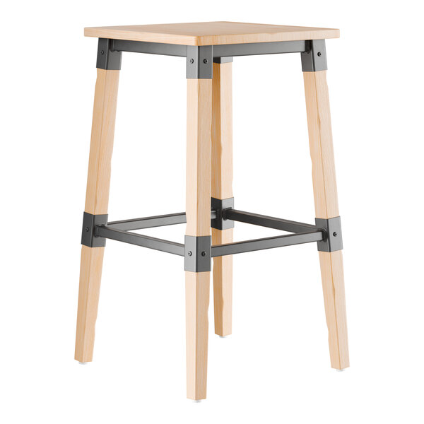 A Lancaster Table & Seating backless bar stool with a bleached oak seat and metal base.