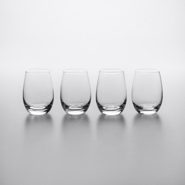 Three Acopa stemless wine glasses on a table.