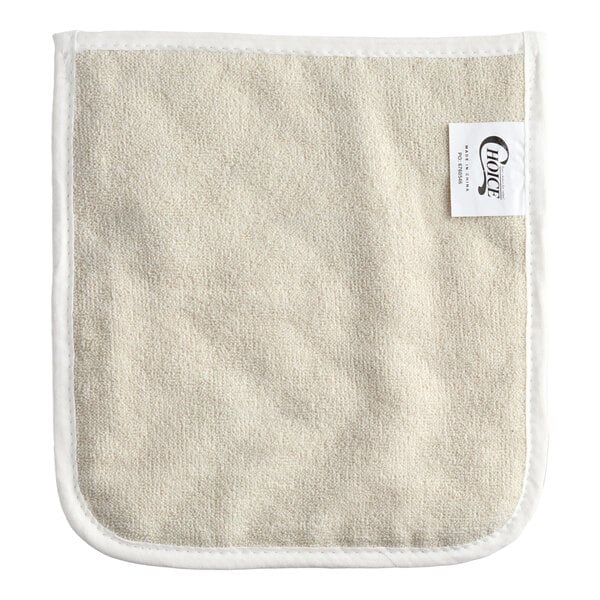 A beige terry cloth pan grabber or baker's pad with white trim and a sewn-in label.