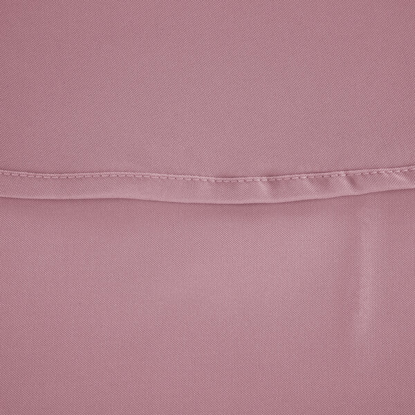 A close-up of a pink fabric with a hemmed edge.