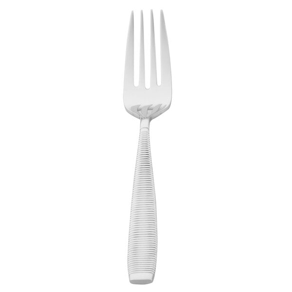 A Walco stainless steel salad fork with a white handle.