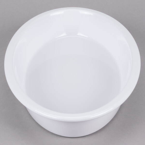 A white oval casserole dish with a round center.