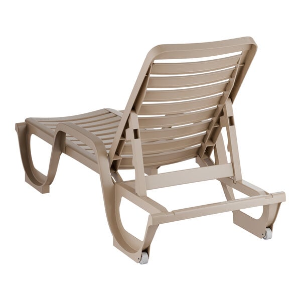 A taupe-colored adjustable resin chaise lounge chair with a slatted design and wheels on the back legs.