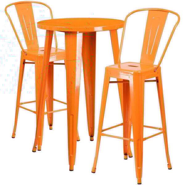 An orange metal bar height table with two orange metal bar stools.