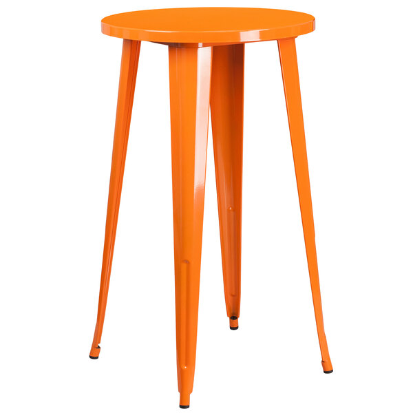 An orange metal table with legs and two orange metal stools.