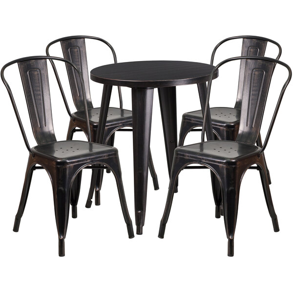 A black metal round table with black metal chairs around it.