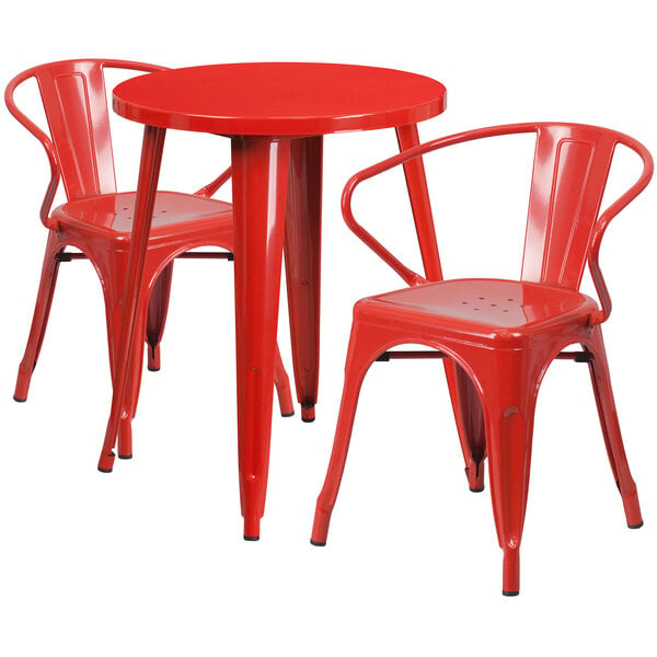 A red round metal table with two red metal chairs with arms.