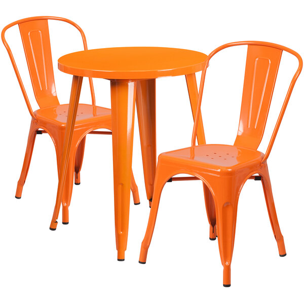 An orange metal table with two chairs.