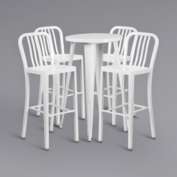 A group of white chairs around a white bar table.