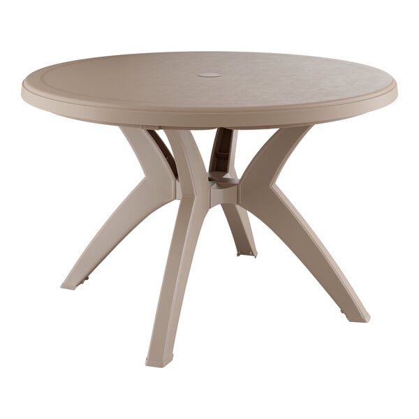 A Grosfillex Ibiza round table with a brown top and legs on a table.