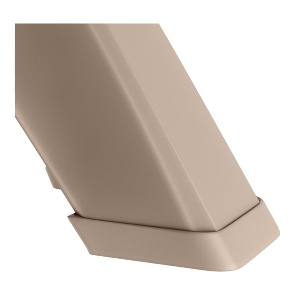 A close up of the corner of a Grosfillex French Taupe resin pedestal table top.