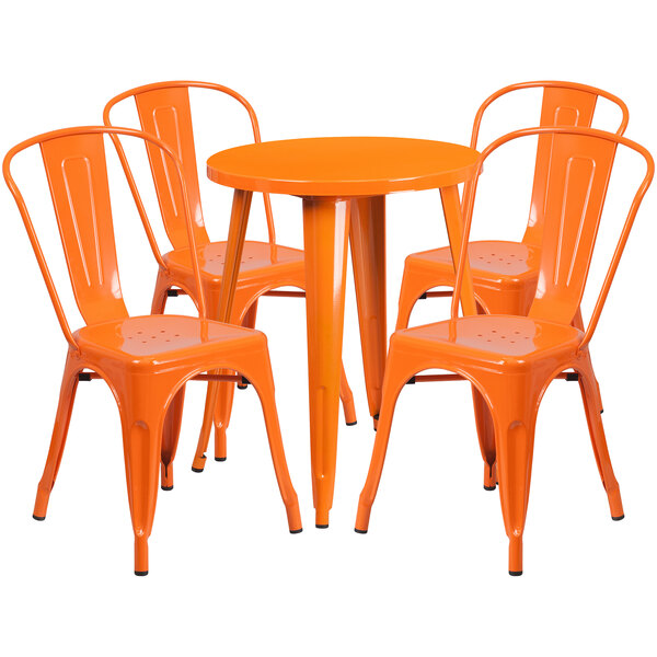 An orange metal table with four orange chairs.