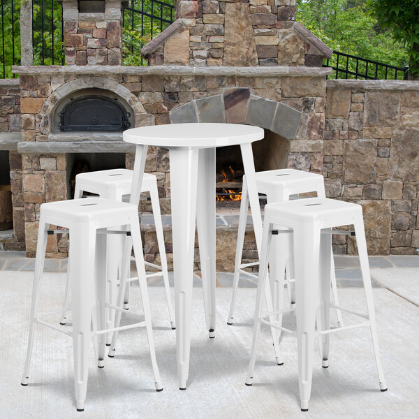 a white stools next to a stone wall