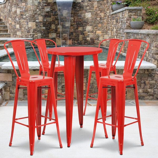 a red table with a stone wall behind it