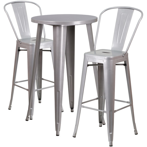 A Flash Furniture metal bar table with a silver surface and two chairs with backrests.