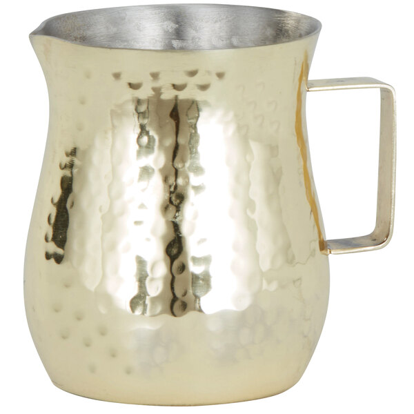 a gold pitcher with a handle