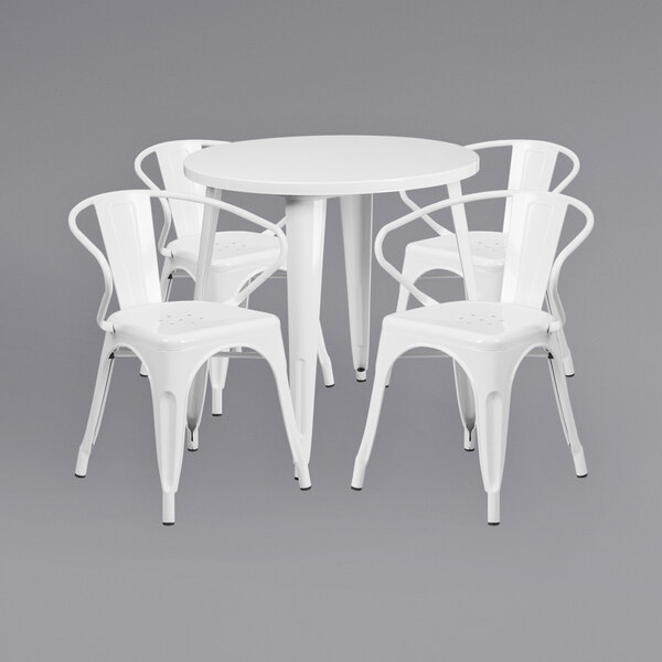 A white Flash Furniture table with four white chairs around it.