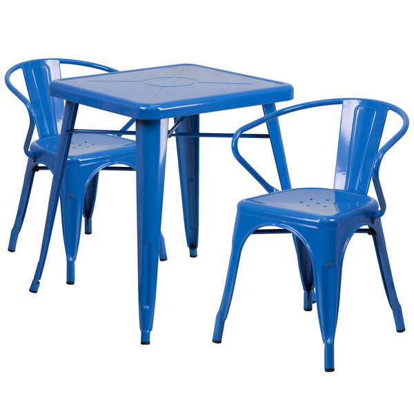 A blue metal table with two chairs on an outdoor patio.