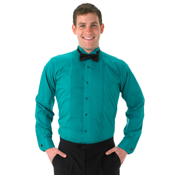 A man wearing a teal tuxedo shirt with a black bow tie and wing tip collar.