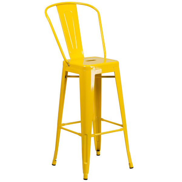 A Flash Furniture yellow metal bar stool with a seat.