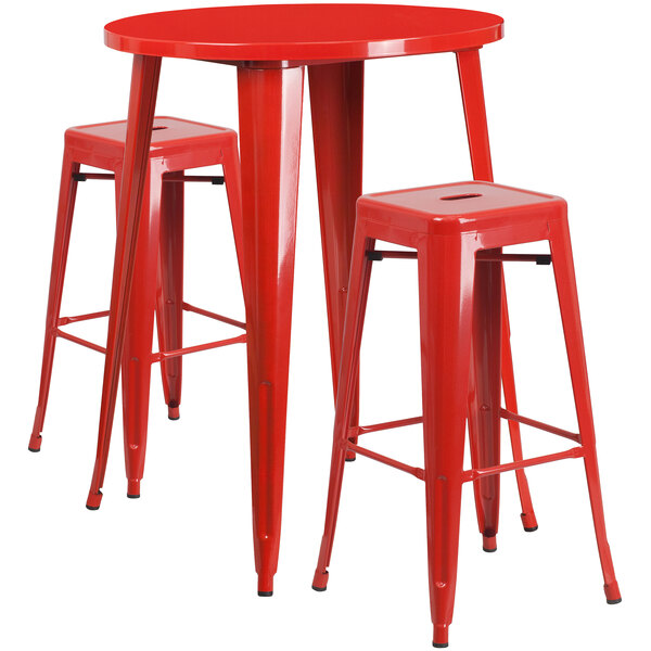 A red table with a white line pattern on the surface and two red metal square stools.