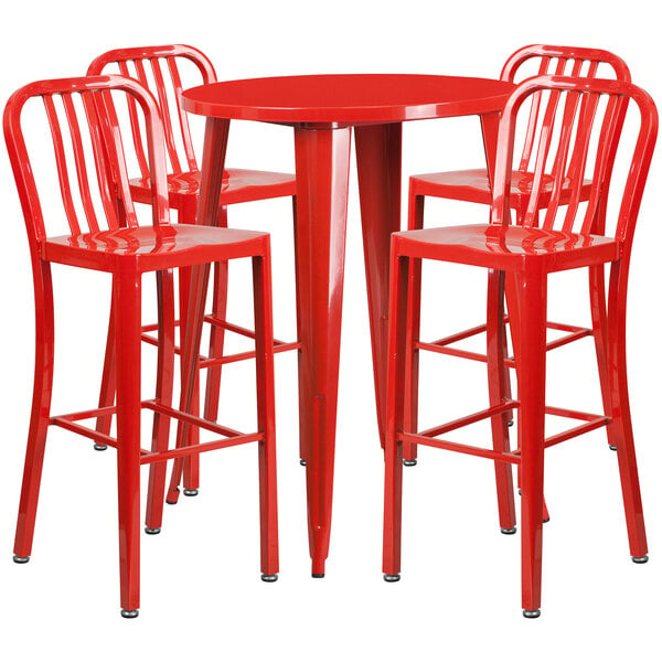 A round red metal bar table with four red vertical slat back chairs.