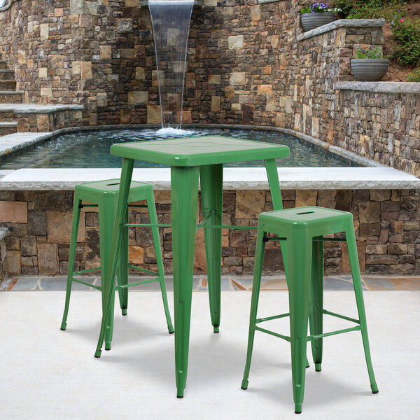 A Flash Furniture green metal bar height table with 2 square stools.