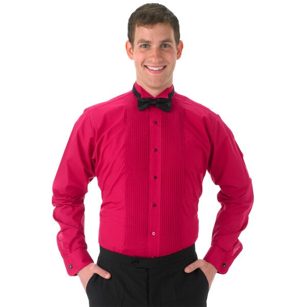A man wearing a fuchsia Henry Segal tuxedo shirt with a wing tip collar and black bow tie.