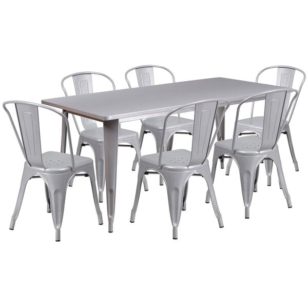 A white rectangular metal dining table with white metal chairs.