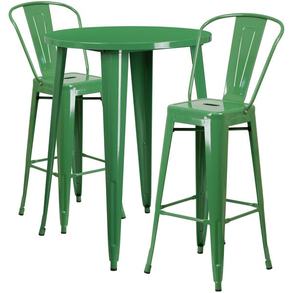 A green metal bar table with two green metal chairs.