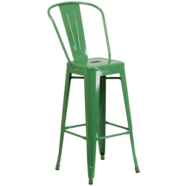 A green metal bar stool with a backrest.