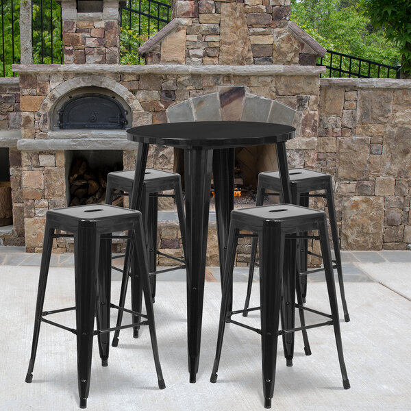 A Flash Furniture black metal bar height table with 4 square backless stools.