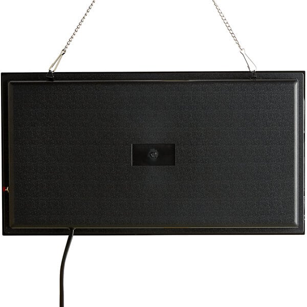 A black rectangular object with a hole in it and a cord hanging from a chain.