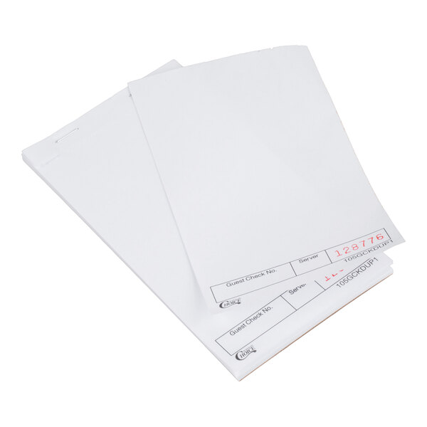 A stack of white blank guest check pads with carbon sheets, used for order taking in restaurants.