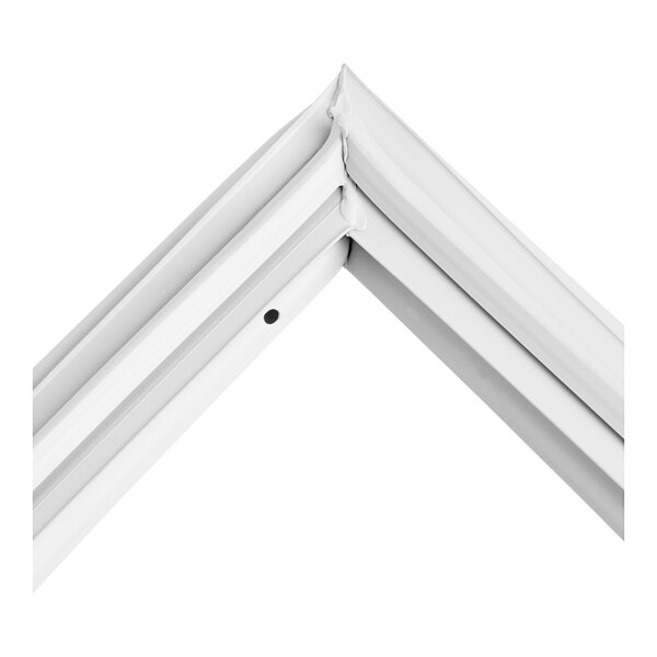 A close-up of a white metal corner gasket.