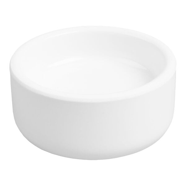 A small, round, white dish with smooth sides and a slightly raised rim.