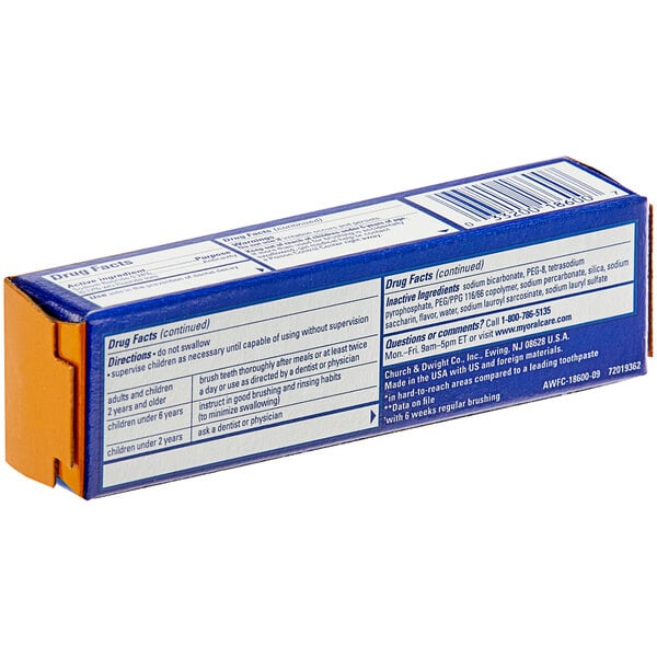 A blue and yellow Arm & Hammer toothpaste box on a counter.