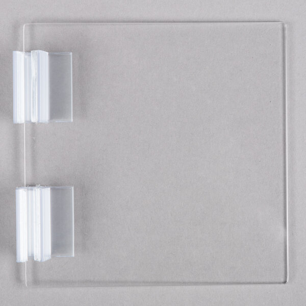 a clear plastic plate with two clear plastic clips